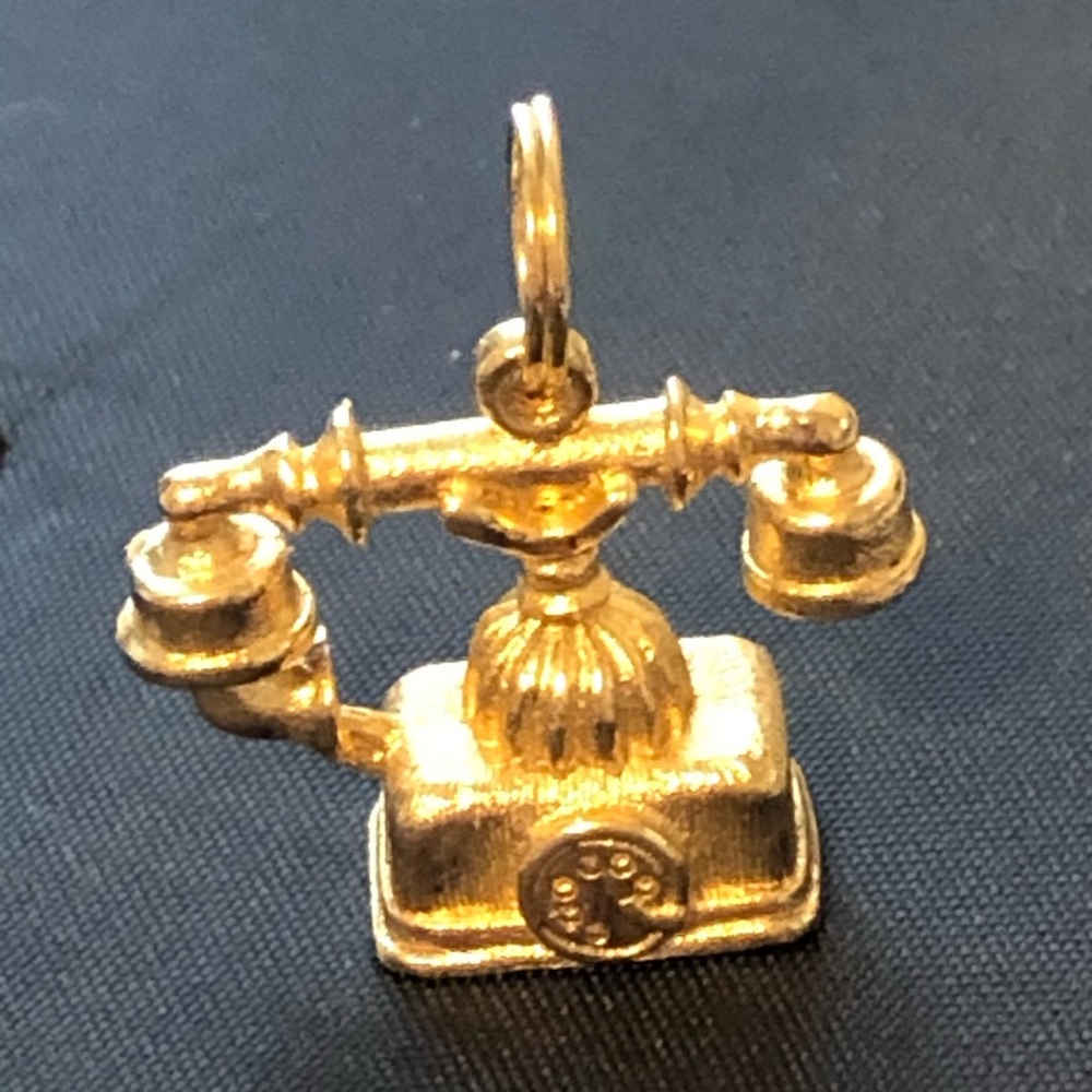 Goldtone charm of old fashioned telephone